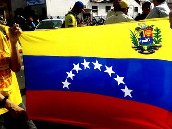 Close-up of yellow flag against blue wall