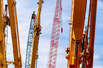 Selective focus on crawler crane against blue sky. real estate industry. red crawler crane.