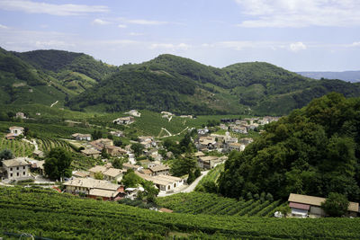 High angle view of townscape and mountains against sky