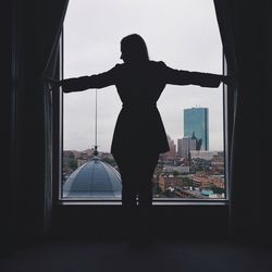 Silhouette of woman against clear sky