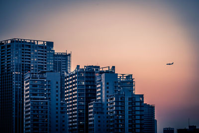 Low angle view of buildings against sky during sunset