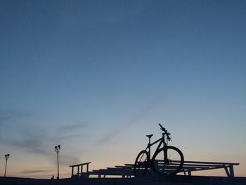 Low angle view of silhouette bicycle against sky