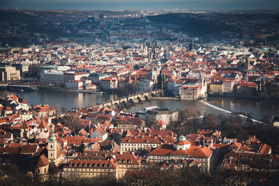 High angle view of town by river against sky
