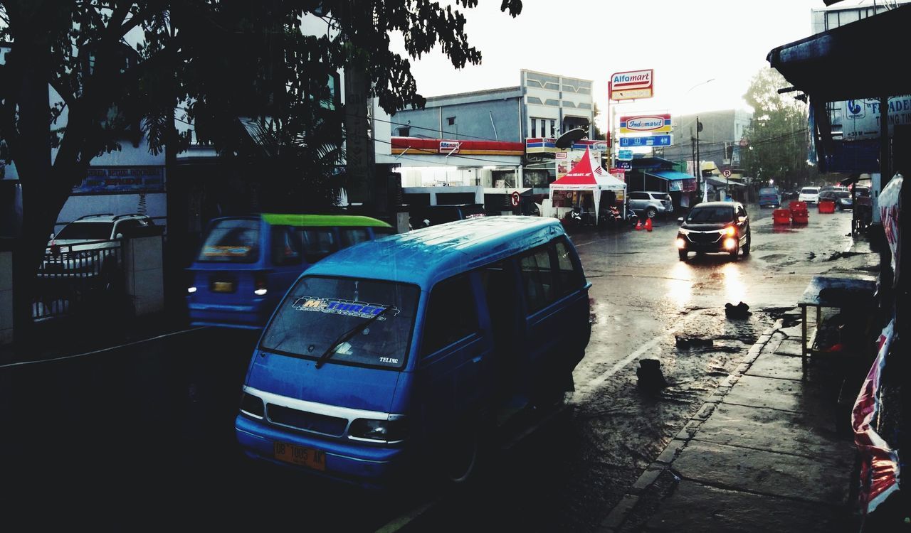 CARS ON ROAD IN CITY