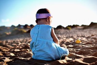 Rear view of woman standing at beach