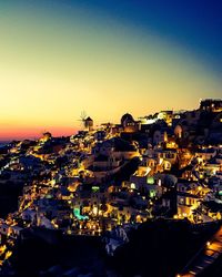 High angle view of illuminated cityscape against sky at sunset