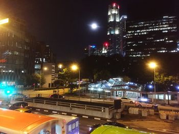 Illuminated city against sky at night