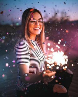 Portrait of smiling young woman using smart phone