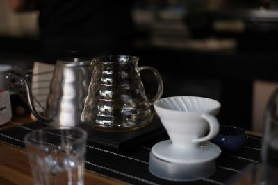 Jar and cup on table