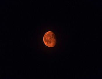 Low angle view of moon against dark sky