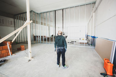 Rear view of construction worker standing at site