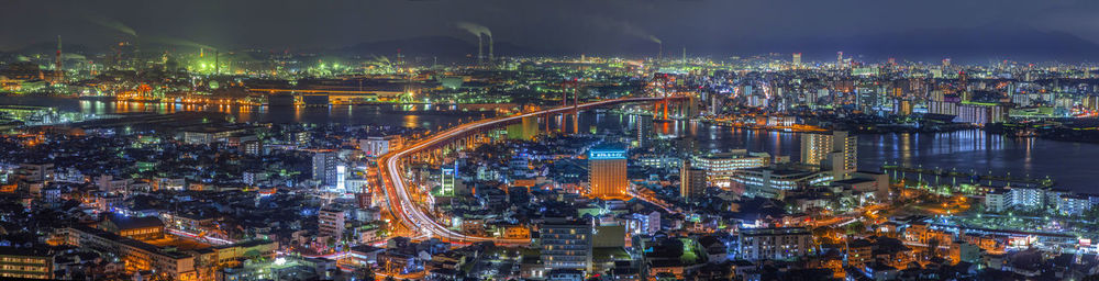 High angle view of city lit up at night