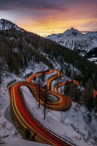 High angle view of snow covered mountain against sky during sunset