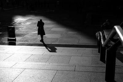 High angle view of man walking on road