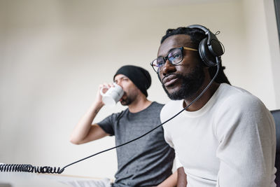 Low angle view of men composing music in studio