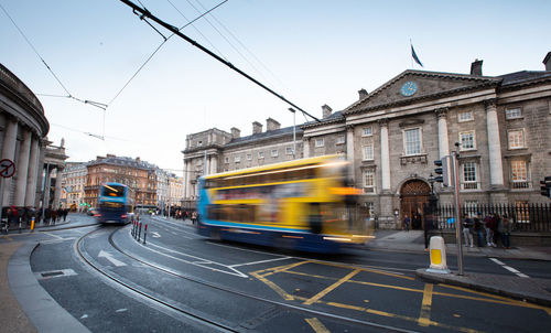 Blurred motion of train on city street