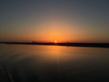 Scenic view of sea against orange sky