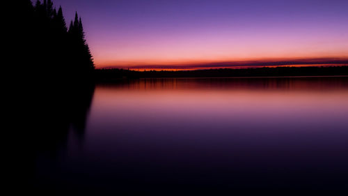 Scenic view of lake against romantic sky at sunset