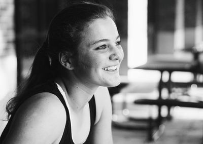 Side view of young woman sitting outdoors