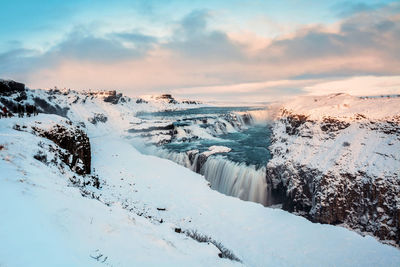 Scenic view of frozen lake against sky during winter