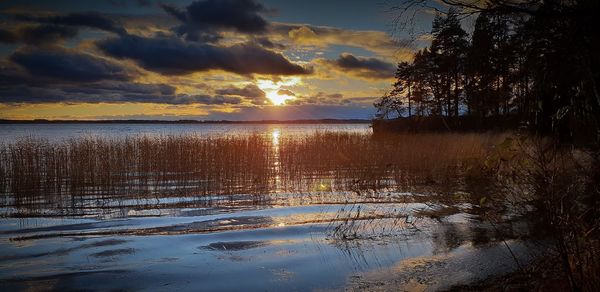 Scenic view of lake against sky during sunset