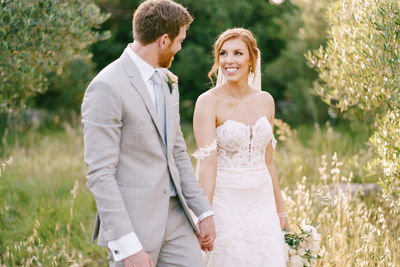 Portrait of couple standing on field