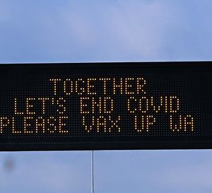 Low angle view of illuminated sign against sky