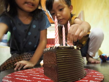 Boy holding candle on cake