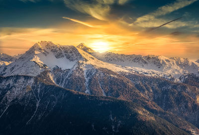 Scenic view of snowcapped mountains against sky during sunset