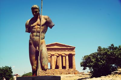 Low angle view of statue against clear blue sky