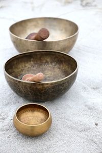 Singing bowl with mallet at the beach