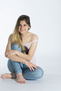 Portrait of a smiling young woman over white background