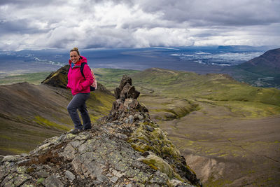 Woman standing on mountain against sky