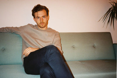 Portrait of man sitting on couch