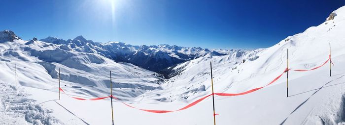 Scenic view of snowcapped mountains against blue sky