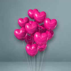 Close-up of pink heart shape over white background