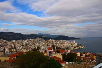 High angle view of townscape by sea against sky