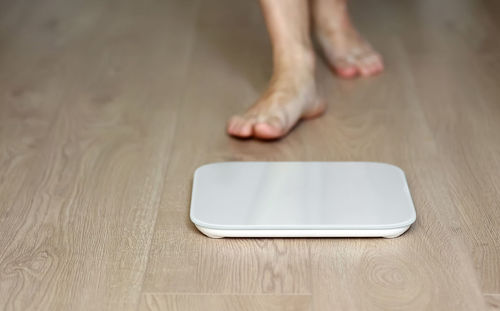 Low section of person standing on table