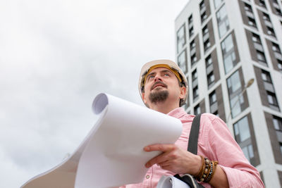 Low angle view of young man looking away