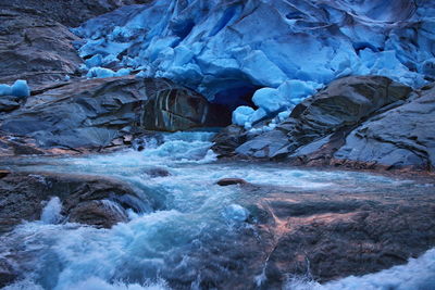 Scenic view of river flowing through cave