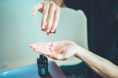 Close-up of hand holding bottle