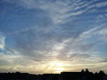 Low angle view of silhouette city against sky