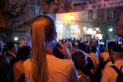 Crowd at music concert in city at night