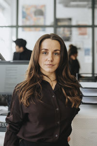 Portrait of female entrepreneur with brown hair at office