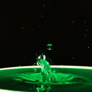 Close-up of water drops on car against black background