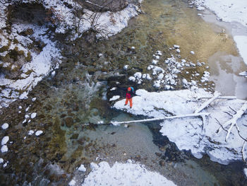 High angle view of man standing by frozen river