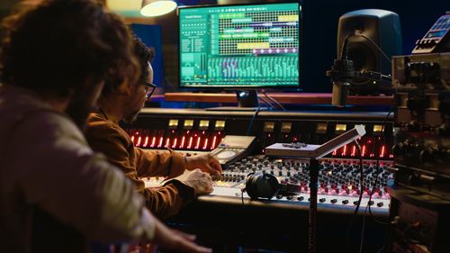 Rear view of woman using sound mixer