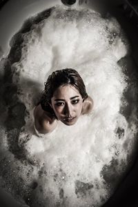 High angle portrait of young woman in bathtub