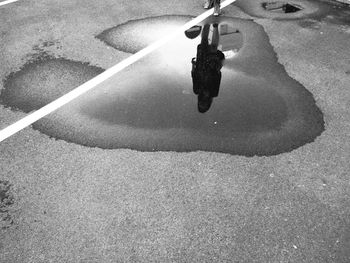 High angle view of person holding umbrella on road