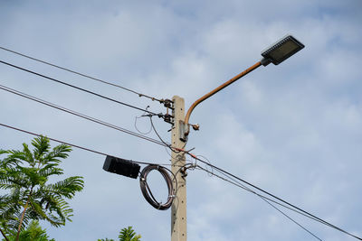 Low angle view of street light against sky